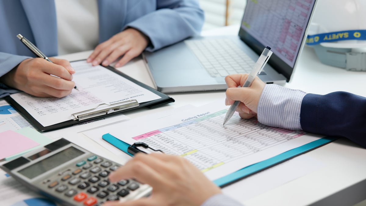 An expert reviewing financial data and reports in a modern audit office